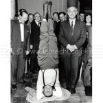 Yehudi Menuhin in yoga position on his head with